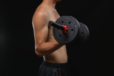 A close-up image showcasing a person's arm holding a dumbbell, emphasizing the strength and dedication required in weight lifting for improving health and fitness. clipart