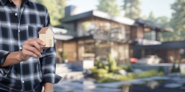 Bu resim, modern mimari bir ortamın önünde minyatür bir ev tutan bir kişinin yer aldığı kiralık konut satın alma ve satma kavramını gösteriyor..