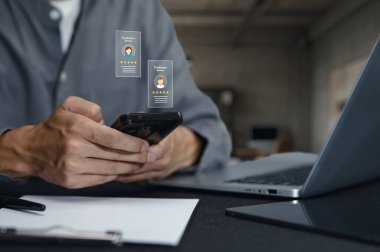 Dijital kartvizitleri göstermek için akıllı telefon kullanan ellerin yakın plan görüntüsü, modern bir çalışma ortamında bağlantı ve etkileşimi gösteriyor.