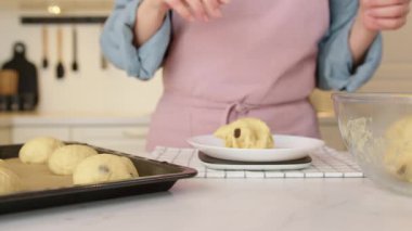 Kuru üzümlü çörekleri şekillendirmek ve Pişirme Tepsisine yerleştirmek