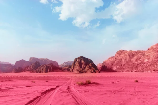 Wadi Rum desert, Jordan. The Valley of the Moon. Blue sky and pink-toned sand.  Abstract pattern. Image toned in the color of the year 2023 viva magenta. Mysterious cosmic landscape, virtual reality.