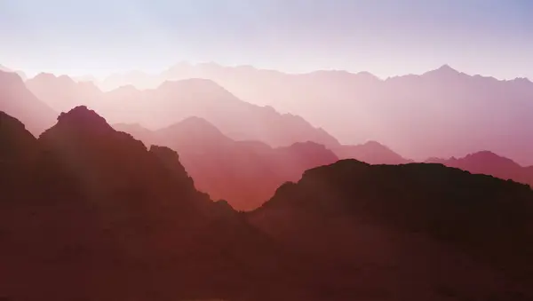 Mountainous terrain in vibrant pink shades. The peaks and valleys, though reminiscent of a natural landscape, carry a surreal quality that aligns with virtual world aesthetics.