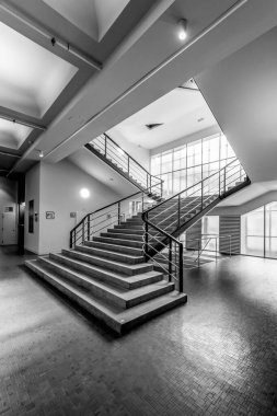 Güçlendirilmiş beton ve kremalı beyaz kaplamalı işlevsel bina. İçerisi geniş bir giriş salonu, kendine özgü bir merdiveni, üst katlarda işlevsel bir patern nosteri ve galerisi var..