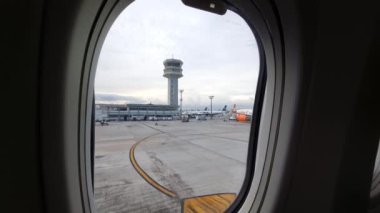 Sao Paulo, SP, Brazil - January 02, 2023: airplane taxiing on Congonhas airport taxiway before flight. View through the window of the plane to the airport.