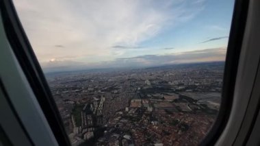 Flying over Sao Paulo - SP, Brazil by plane. Passenger view through the airplane window during afternoon.