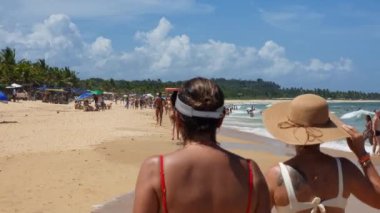 Trancoso, district of Porto Seguro, BA, Brazil - January 06, 2023: people at Nativos beach on a sunny day, a beautiful beach in northeastern Brazil. Tourist destination of Trancoso.