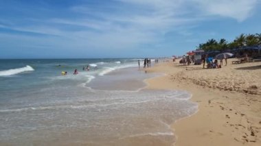 Trancoso, district of Porto Seguro, BA, Brazil - January 06, 2023: walking on Nativos beach, a beautiful beach in northeastern Brazil. Tourist destination of Trancoso.
