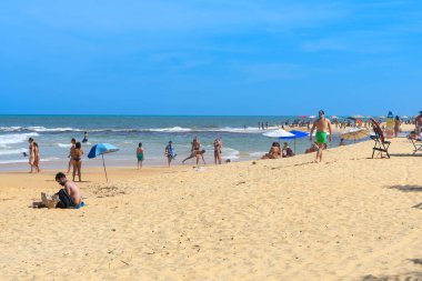 Trancoso, district of Porto Seguro, BA, Brazil - January 06, 2023: people on Nativos Beach enjoying the day on the beach. clipart