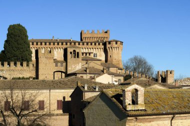 The castle of Gradara seen from afar with copy space in the sky. Gradara is a middle age italian village near Urbino famous for the stoy of Paul and Francesca in Dante Alighieri Divine Comedy