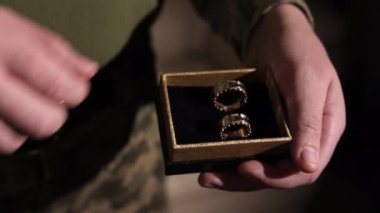 Marriage proposal, Soldier engagement, Engagement celebration. Holding onto the rings, a war veteran plans to propose to his partner.