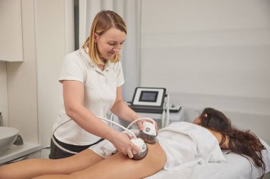 lifting body, Anti-cellulite, modern medical. Anti-cellulite roller-vacuum massage procedure is available in beauty salon to treat cellulite problem areas. Body care professional equipment