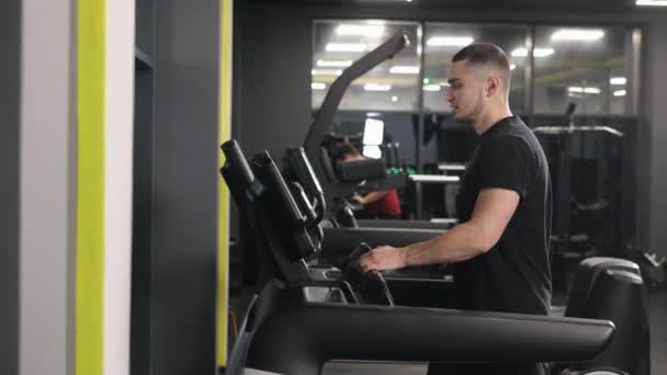 有氧运动 心脏健康 健美跑步机 这个人正在体育馆里进行一项体育活动 — 图库视频影像