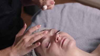 Lüks yüz bakımı, güzellik terapisi, ultraviyole cilt bakımı. Kadın cilt bakımı uzmanı hastalara SPF güneş savunması sağlıyor..