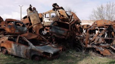 Araba mezarlığı, savaş tahribatı, havan topu. Rus saldırganlığının sonucu olarak, yanan arabalar şehirde yaygındı..