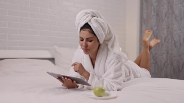 Using Tablet Bedroom Comfort Stomach Lying Woman Savors Her Downtime — Stock Video