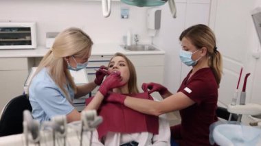 Trusted Care, Cavity check, Preventative examination. Medical professional checks patients oral cavity for tooth decay, providing advice on caries protection and remedial procedures.