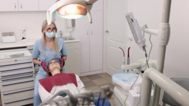 Jaw joints, Orthodontic specialist, Woman consultation. Gnathologist, who is also orthodontist, is examining jaw joints of female patient through touch.
