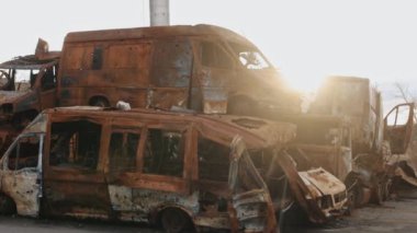 Yanmış arabalar, Akıbet mermisi, hasarlı araba. Arabanın tahrip edilmesi, sivil araca füze saldırısı, Ukrayna 'da savaş, Rus istilası, araba yakma, şehir harabeleri, felaket sonrası.