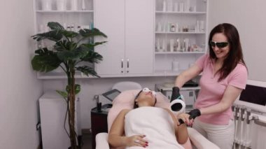 Pürüzsüz cilt, lazer gençleştirme, ipl kozmetoloji. Kozmetik ve kaplıca kavramı, genç bir kadının bacağında lazer tedavisi gören lazer epilasyonu.
