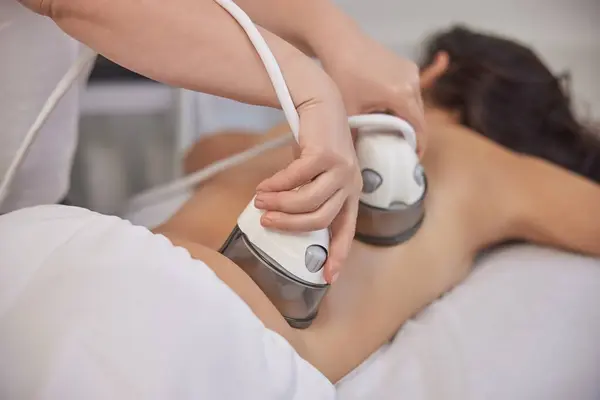 receiving massage, Vacuum massage, medical procedures. Vacuum body massage can help reduce fat in problem areas, slimming of problem areas, special body care equipment for slimming, lpg procedure