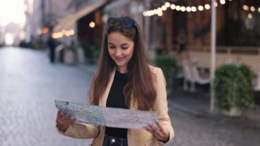 Seyahat güzergahı, konum haritası, arama yönü, modaya uygun gezen güzel bayan turist, yazın bavulla yurtdışına seyahat ederken haritada yerini arıyor, seyahat ediyor..