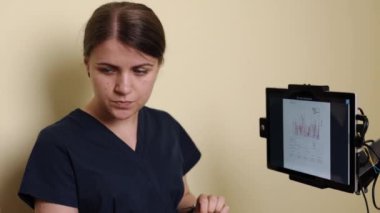 Eyalet sağlığı, tıbbi analiz, klinik değerlendirme. Klinikte dokunmatik ekrandan yararlanan profesyonel terapist, hastaların rehabilitasyonunu değerlendirmek için gerçek zamanlı istatistik ve grafikleri inceliyor