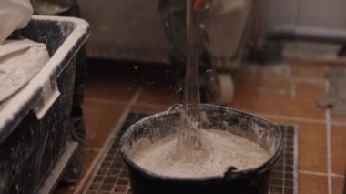 Su birleştirme, hazırlık teknikleri, alçı çözümler. İnsan alçı taşı modelini asal alır ve suyu alçıtaşıyla karıştırır.