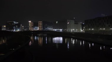 Şehir ışıkları, gece manzarası, yansıtıcı su. Berlin 'de, nehir aynaları geceleri çağdaş yapılar parlıyor..