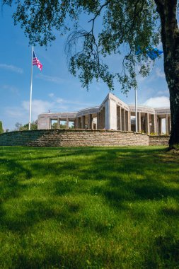 Bastogne, Luxembourg, Belgium - JULY 17, 2021: Mardasson Mermorial remembering Battle of the Bulge. American & EU flags in the foreground clipart