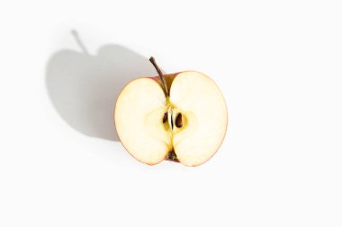 Half of a cut apple on a white background. Top view, flat lay.