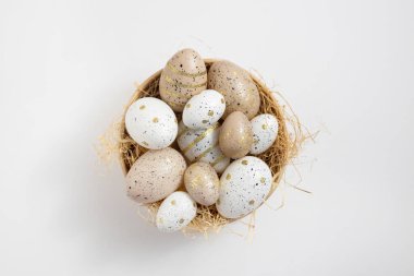 Bowl with Easter eggs on a white background.