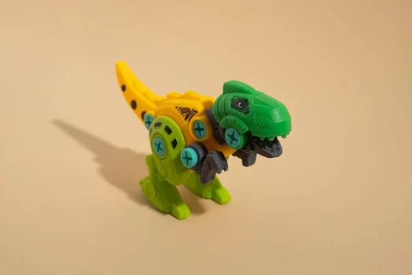Plastic toy dinosaur on a light background.