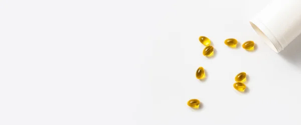 stock image Vitamin omega 3 capsules pills fish on a white background. Top view, flat lay. Banner.