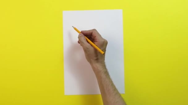 Hand Hält Bleistift Und Leeres Blatt Auf Gelbem Hintergrund — Stockvideo
