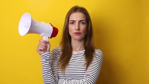 Young Woman Speaks Megaphone Yellow Background — Stock Video