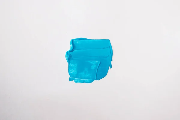 Stock image Blue smear on a white background. Top view, flat lay.