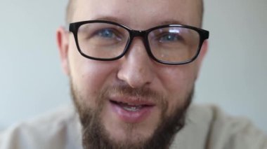 Konuşan gözlüklü genç adam..