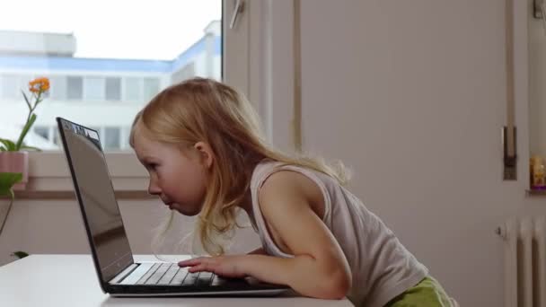 Child Girl Blonde Imagines Actively Typing Laptop — Stock Video