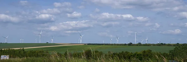 Windmills for electricity generation. Wind turbine farm, windmill farm producing green energy.