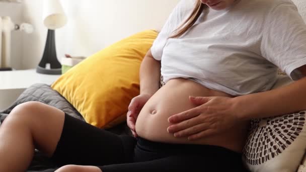 妊娠中の母親は彼女の腹を打ち 彼女の生まれていない子供に話す — ストック動画