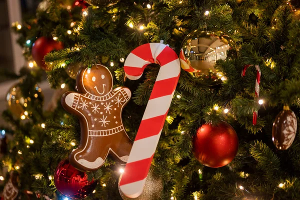 christmas tree for christmas with garland and decorations and candy cane santa claus with gingerbread man