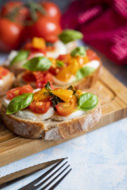 crispy bruschetta bread with mozzarella cheese with tomatoes and basil