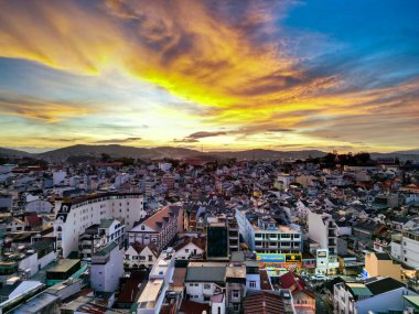 Vibrant Sunset Skyline: HDR Shot of Da Lat City, Vietnam with Mesmerizing Blend of Colors between Cityscape and Sky at Dusk