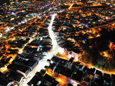 Illuminated Night View of Da Lat City, Vietnam: A Captivating Display of City Lights against the Dark Starry Sky