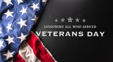 Happy Veterans day concept made from American flag and the text on dark wooden background.