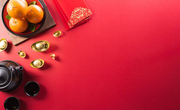 Chinese new year decorations made from red packet, orange and gold ingots or golden lump. Chinese characters on the object means to fortune, good luck, wealth, and money flow.