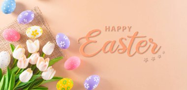 Happy easter! Colourful of Easter eggs in with flower and the text on pastel background. Greetings and presents for Easter Day celebrate time.