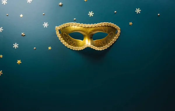 Happy Purim carnival decoration concept made from golden mask star and glitter on dark background. (Happy Purim in Hebrew, jewish holiday celebrate)