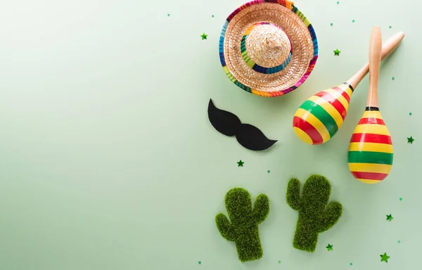 Stock image Cinco de Mayo holiday background made from maracas, mexican blanket stripes or poncho serape, cactus and hat on pastel background.