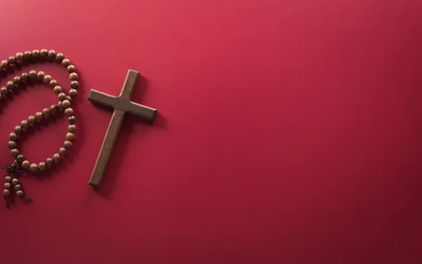 Good Friday and Holy week concept - A religious cross on dark red background.
